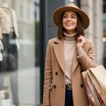 Stylish woman confidently showcasing designer-inspired outfit on a budget